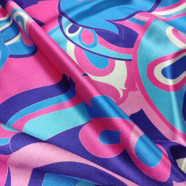 Tessuto Lycra lucida a fantasia motivo astratto fucsia - azzurro - rosa