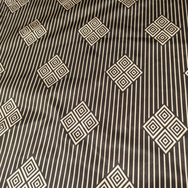 Tessuto Satin a fantasia motivo astratto beige scuro - nero