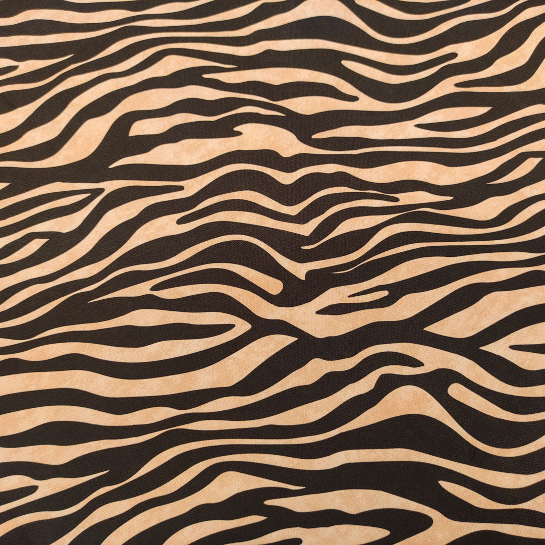 Tessuto Cady elasticizzato a fantasia motivo animalier cammello - nero