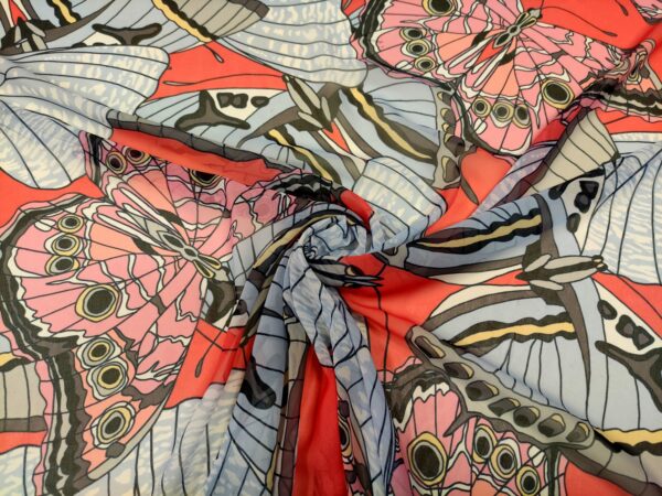 Tessuto Georgette a fantasia motivo astratto celeste - rosso