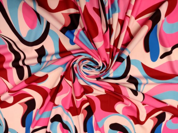 Tessuto jersey a fantasia motivo astratto fucsia - celeste - nero