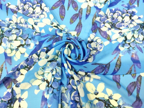 Tessuto Chiffon a fantasia motivo floreale turchese - bianco