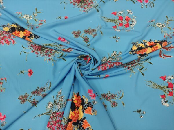 Tessuto Crepe a fantasia motivo floreale turchese - fucsia