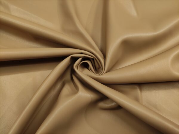 Tessuto Ecopelle per abbigliamento doppiato con camoscio tinta unita cammello