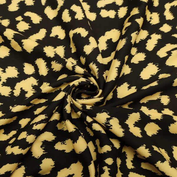 Tessuto Cady elasticizzato a fantasia motivo animalier nero - giallo