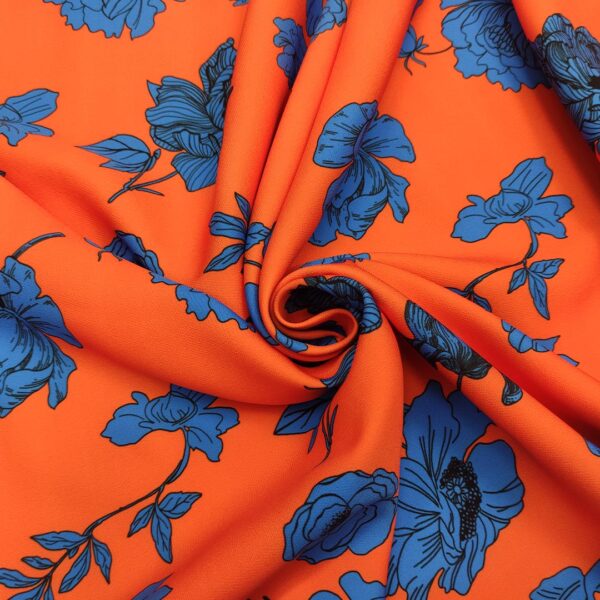 Tessuto Cady elasticizzato a fantasia motivo floreale arancione - blu elettrico