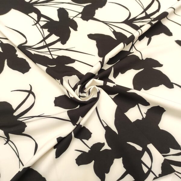 Tessuto Cady elasticizzato a fantasia motivo floreale nero - panna