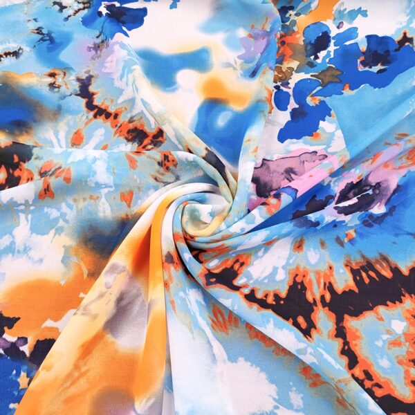 Tessuto Georgette a fantasia motivo astratto turchese - arancione - bluette