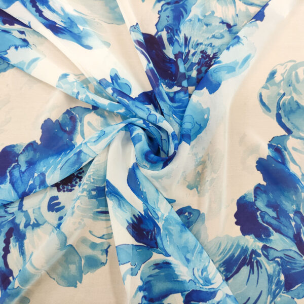Tessuto Georgette a fantasia motivo floreale bianco - blu elettrico