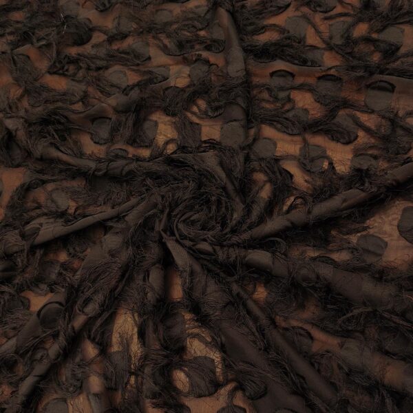 Tessuto Georgette con frange motivo pois nero