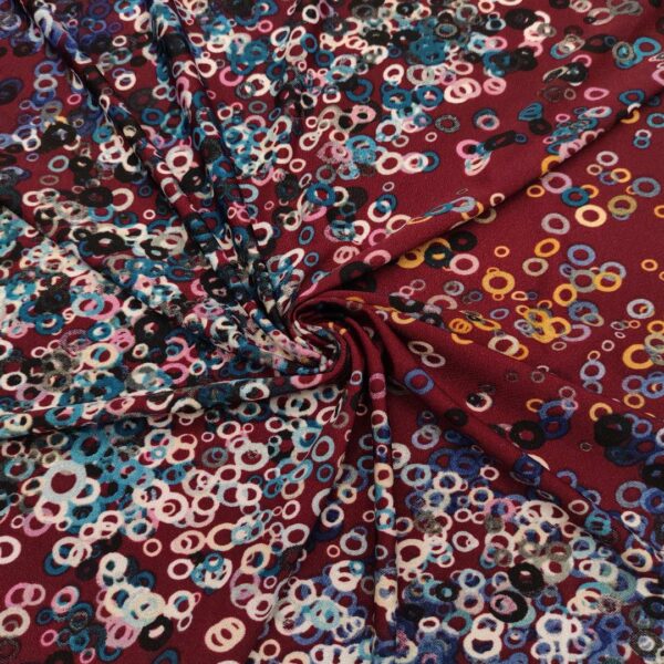 Tessuto Jersey a fantasia motivo astratto bordeaux - celeste - ocra - rosa