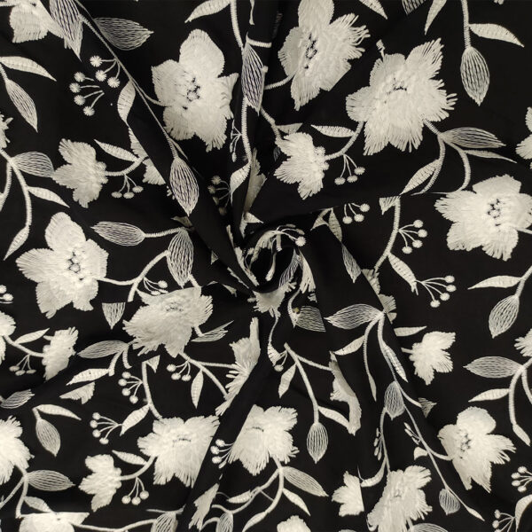 Tessuto Mussola di Cotone ricamato motivo floreale nero - bianco