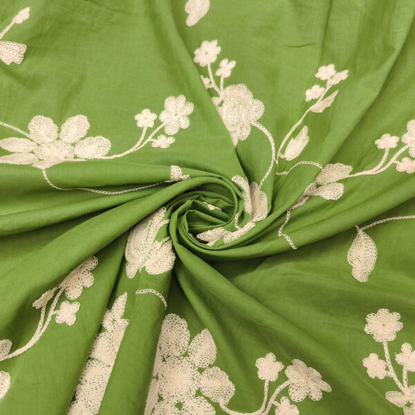Tessuto Mussola di Cotone ricamato motivo floreale verde - bianco