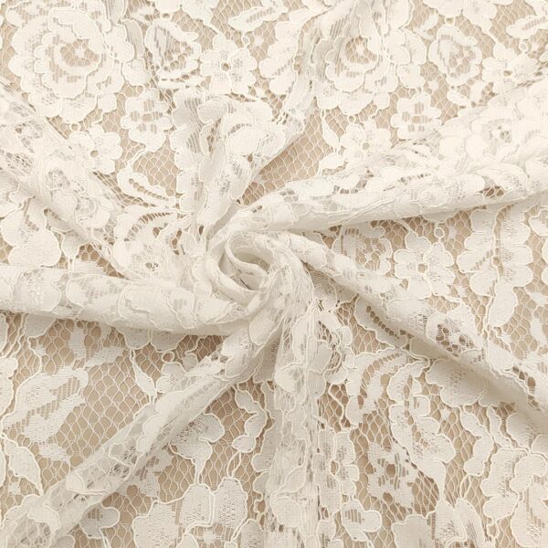 Tessuto Pizzo Rebrodè tinta unita motivo floreale bianco ottico