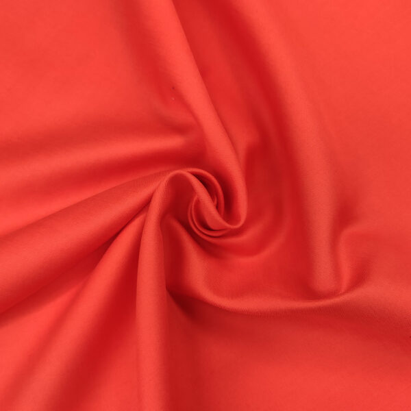 Tessuto Popeline di cotone in tinta unita corallo