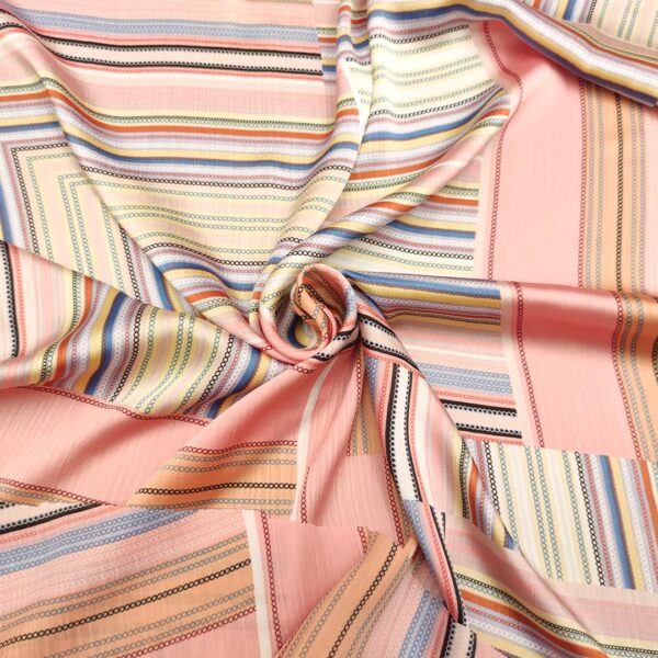 Tessuto Satin elasticizzato a fantasia motivo geometrico corallo - celeste - ocra - nero