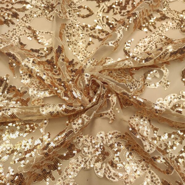 Tessuto Tulle mano seta ricamato con paillettes motivo etnico oro