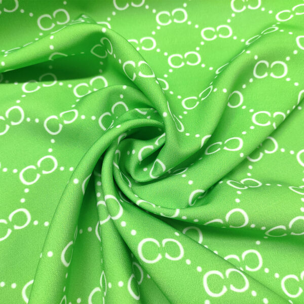 Tessuto Cady elasticizzato a fantasia motivo astratto verde - bianco