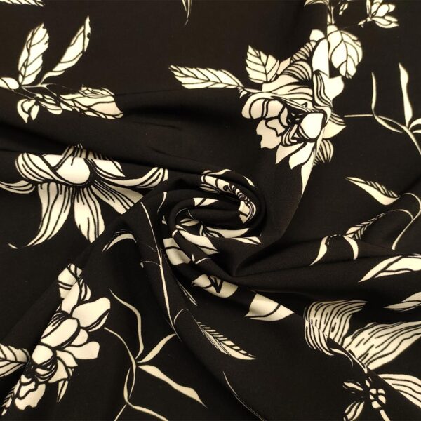 Tessuto Cady elasticizzato a fantasia motivo floreale nero - bianco