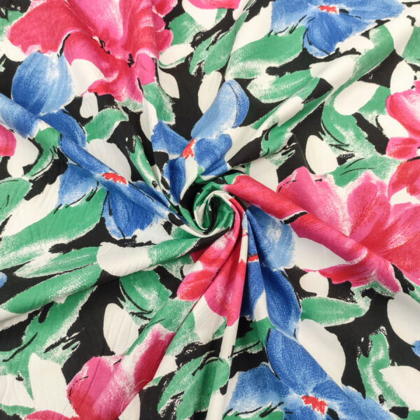 Tessuto Cotone leggero a fantasia motivo floreale nero - azzurro - fucsia
