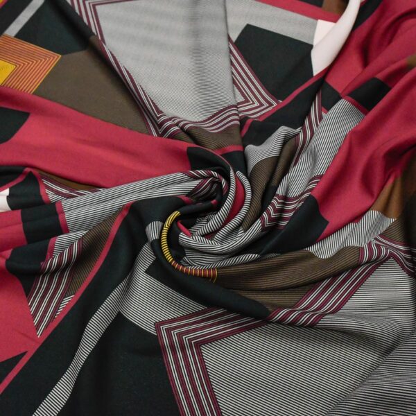 Tessuto Crepe a fantasia motivo astratto lampone - giallo - nero