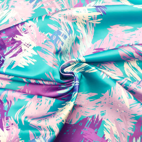 Tessuto Duchesse a fantasia motivo astratto turchese - viola - lilla