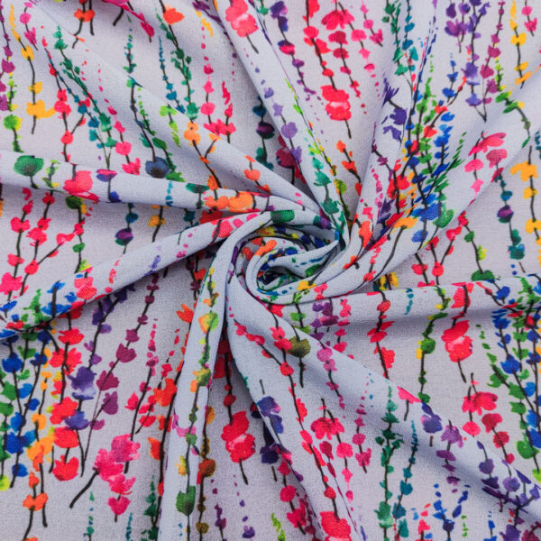 Tessuto Georgette a fantasia motivo astratto celeste - verde - fucsia