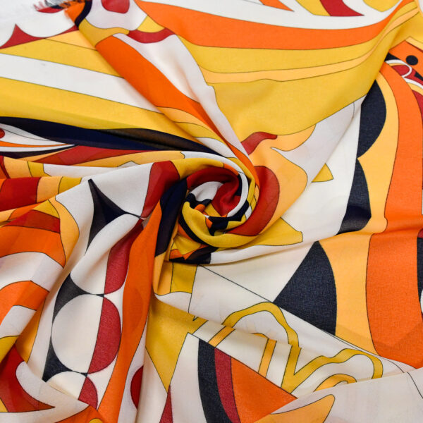 Tessuto Georgette a fantasia motivo astratto giallo - arancione - blu
