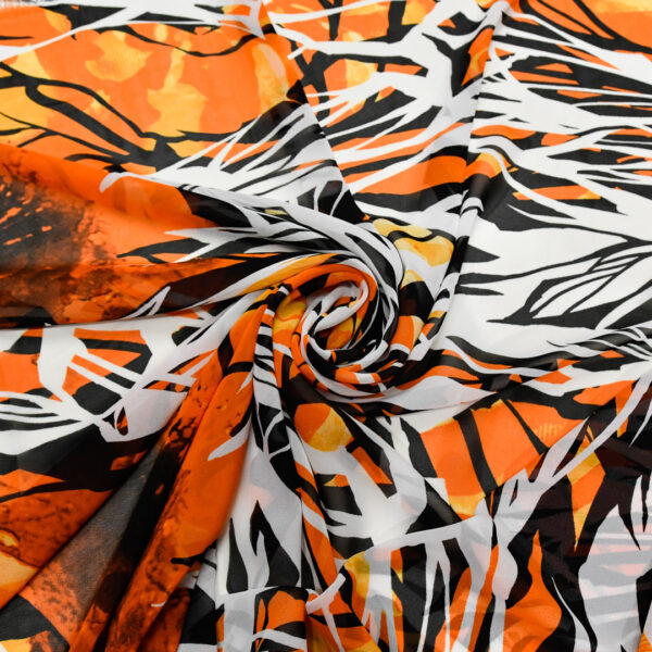 Tessuto Georgette a fantasia motivo astratto nero - bianco - arancione