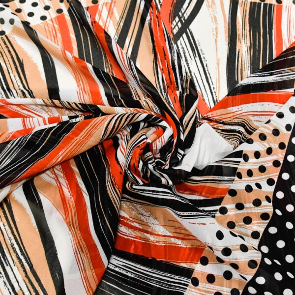 Tessuto Georgette a fantasia motivo astratto nero - rosso - bianco