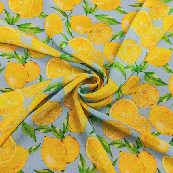 Tessuto Georgette a fantasia motivo astratto verde - celeste - giallo