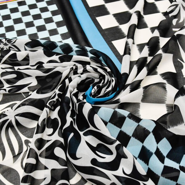 Tessuto Georgette a fantasia motivo geometrico bianco - nero - turchese