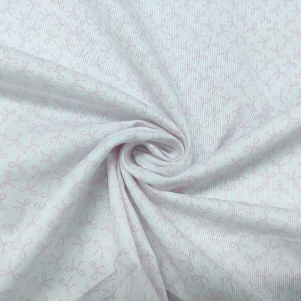 Tessuto Millerighe di Cotone a fantasia motivo fiocchi bianco - rosa