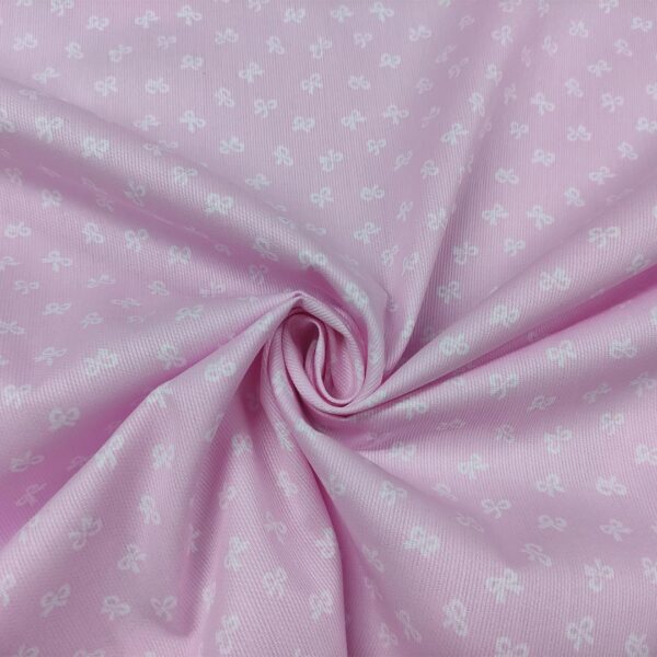 Tessuto Millerighe di Cotone a fantasia motivo fiocchi rosa - bianco