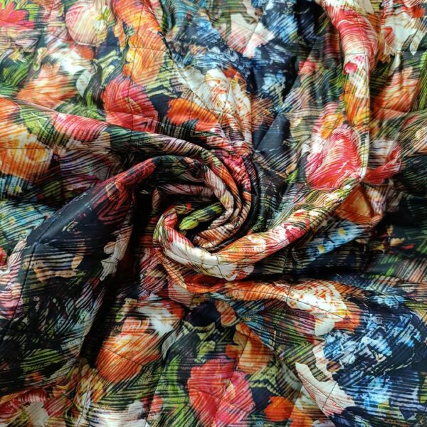 Tessuto Trapunta a fantasia motivo floreale nero - arancione - verde