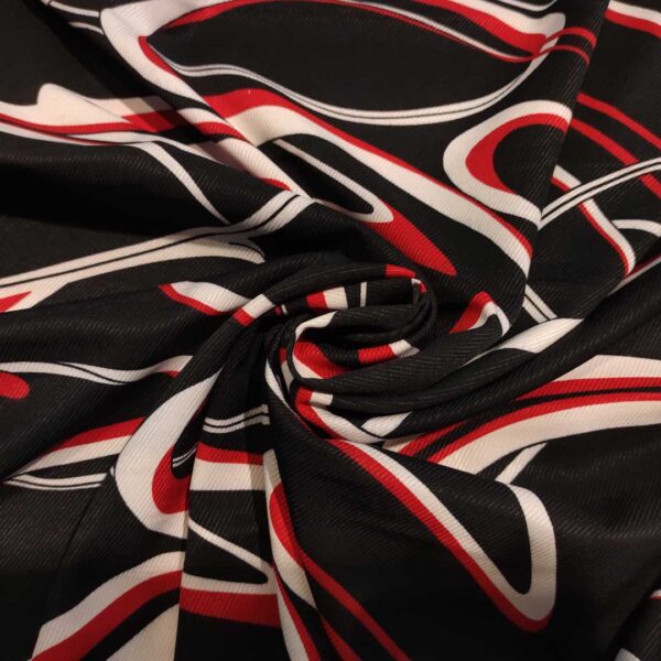 Tessuto Crepe elasticizzato a fantasia motivo astratto nero - rosso - bianco