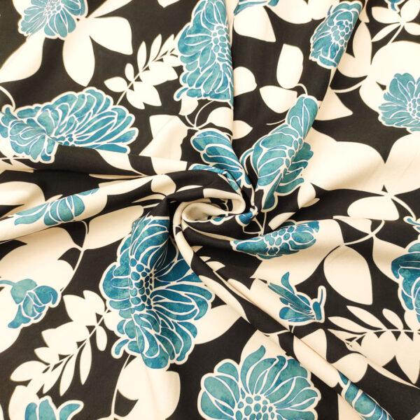 Tessuto Cady elasticizzato a fantasia motivo floreale nero - panna - ottanio