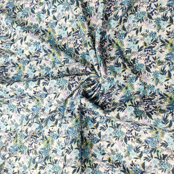 Tessuto Cotone leggero a fantasia motivo floreale celeste - lilla - carta da zucchero