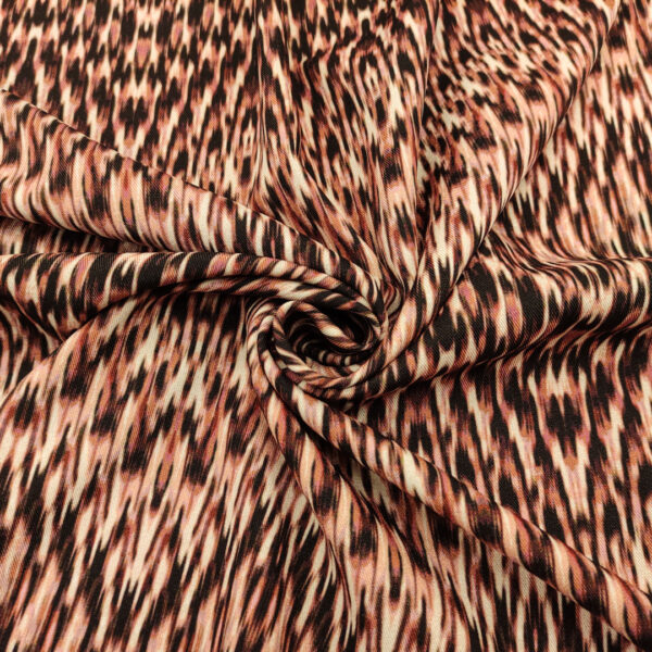 Tessuto Crepe elasticizzato a fantasia motivo astratto rosa - nero - pesco