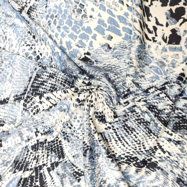 Tessuto Jersey di cotone a fantasia motivo astratto celeste - blu - bianco
