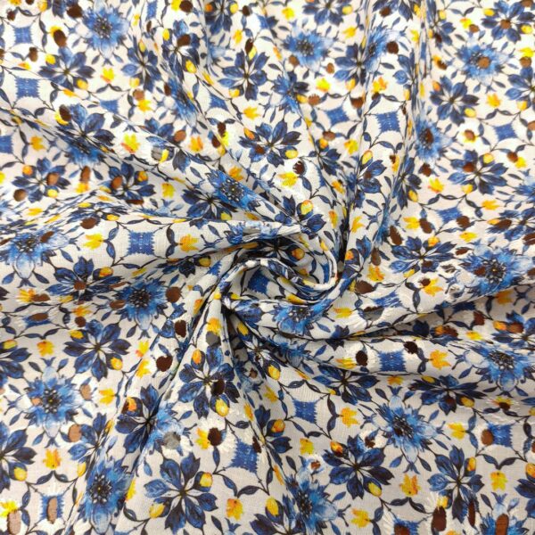 Tessuto Sangallo a fantasia motivo floreale bianco - blu - giallo