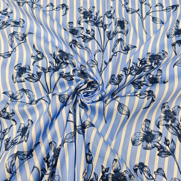 Tessuto Popeline di cotone a fantasia motivo floreale rigato celeste - bianco - blu